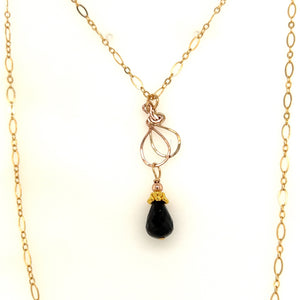 Black spinel drop with a 14 karat gold filled chain measuring 18 inches.