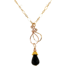 Black spinel drop with golden chain-measuring 18 inches with a lobster clasp.