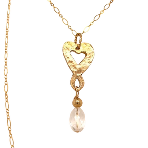 Hand cut brass heart necklace with a crystal quartz drop measuring 18 inches. The drop is two inches. One of a kind.