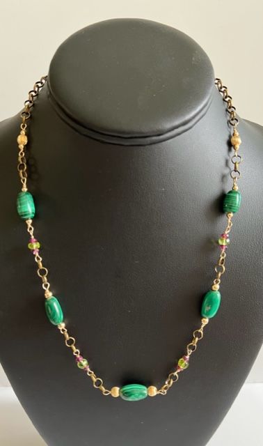 Malachite, Rhodolite Garnet, Peridot wire wrapped necklace with gold accents. Measuring 21 inches with a 3 inch extender.