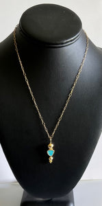18 inch 14 karat gold filled chain with secure lobster clasp. Natural turquoise drop pendant surrounded by gold balls. pendant measures 1 and 3/8 inches from top to bottom and 7/8 inches wide.