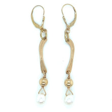 Gold filled lever back earrings with gold freeform metal and white pearl drop.